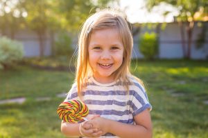Smiling child with lollipop